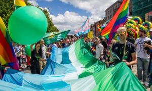 Green Party members march in the Pride parade with a transgender flag in 2018