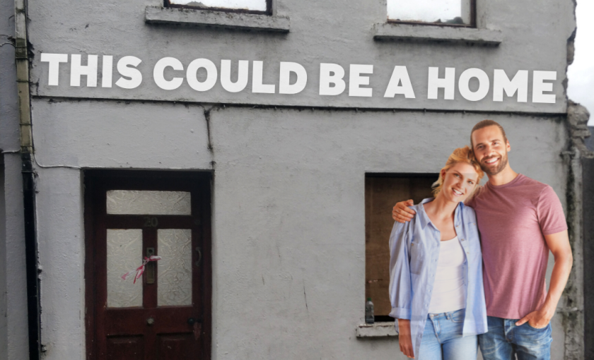 Young couple standing outside a vacant house with the line 'This could be a home'