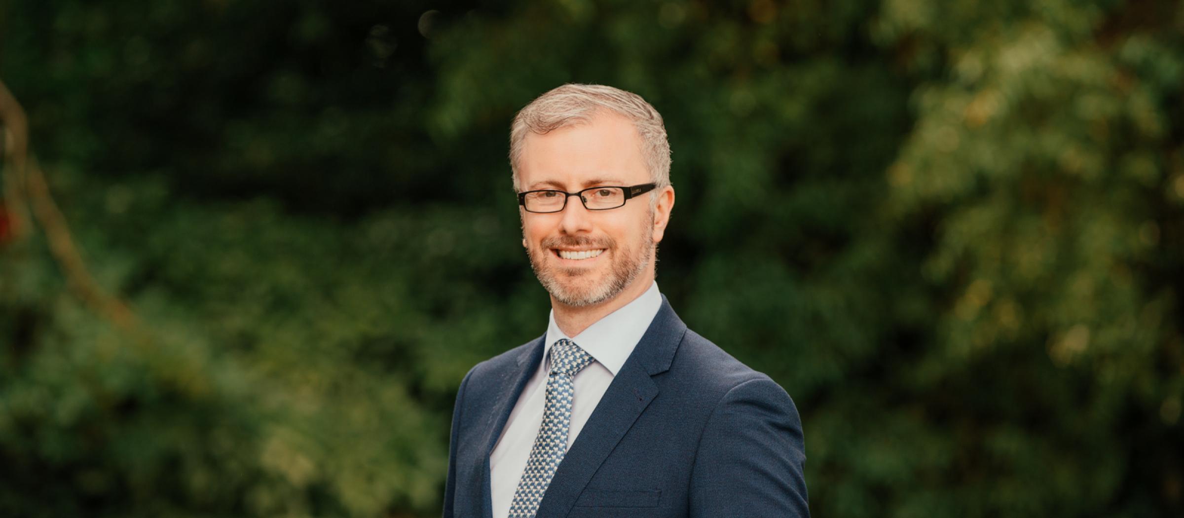 Profile photo of Minister Roderic O'Gorman with trees in the background