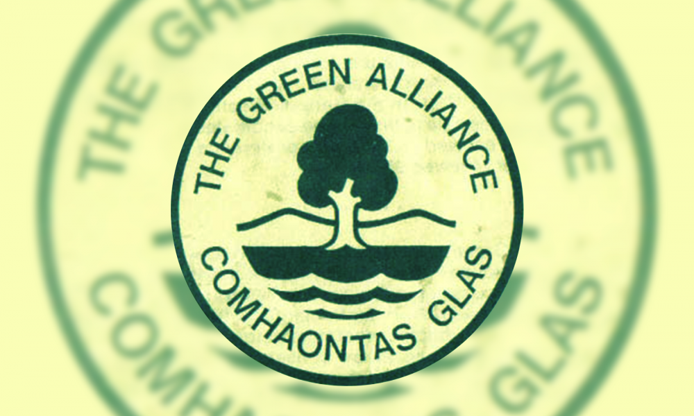 A green icon of a tree, water and hills, with the words 'The Green Alliance Comhaontas Glas' encircling it.