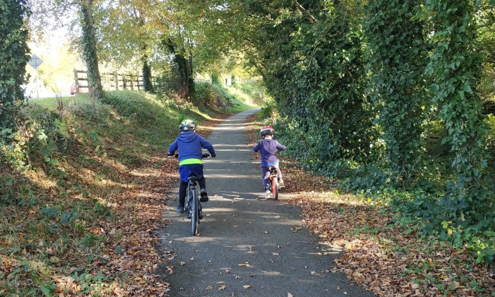 Two children cycle along the Limerick Greenway