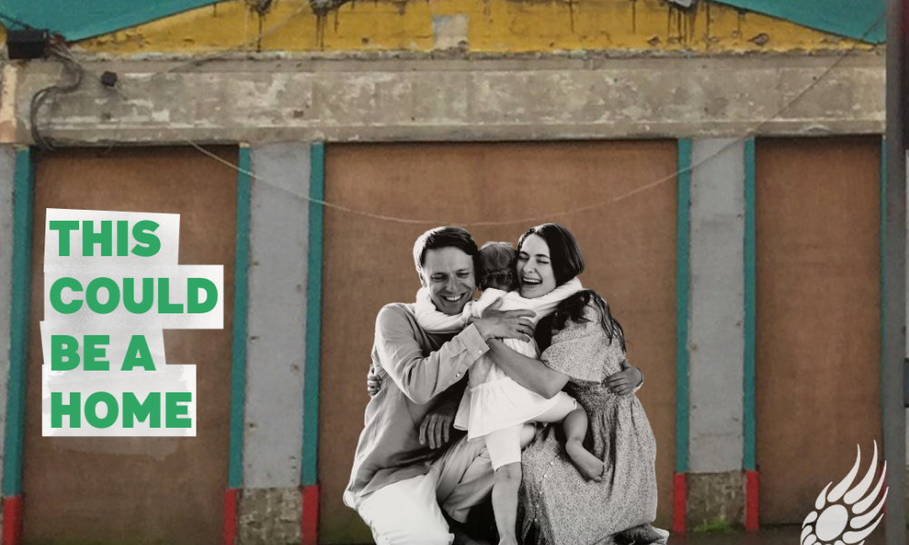 This could be a home - image of a young family infront of a derelict building