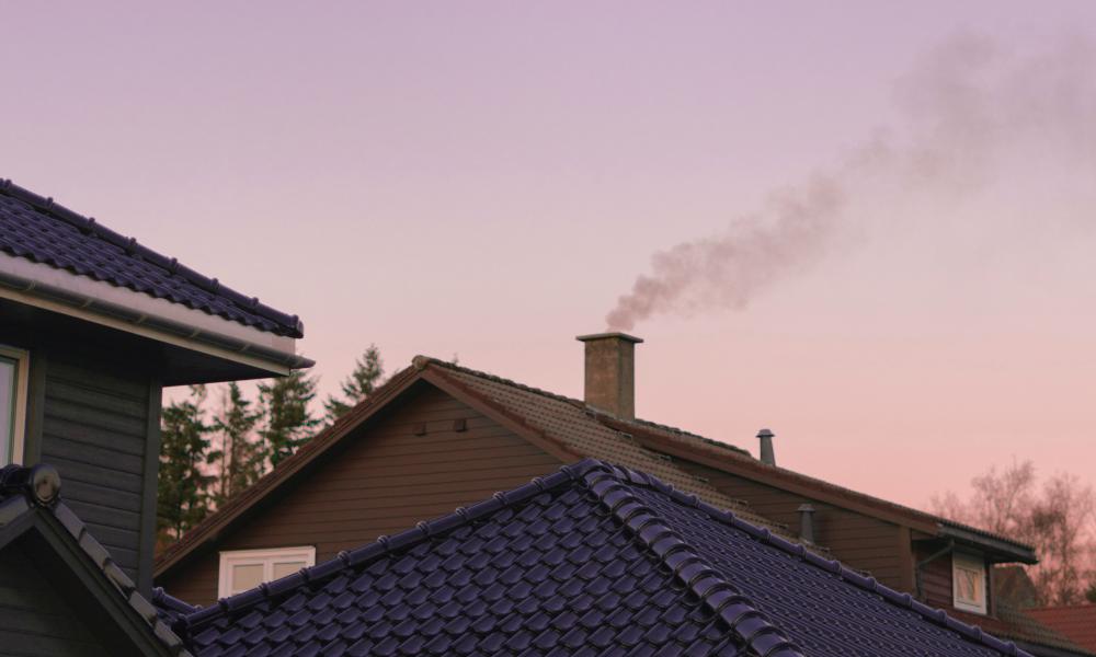 Smoke coming from a house chimney