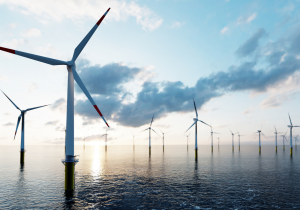 Offshore wind turbines against a blue sky and clouds