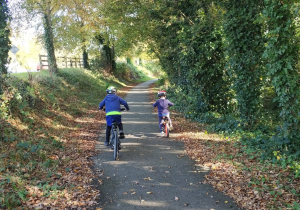 Two children cycle along the Limerick Greenway