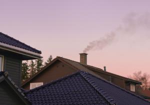 Smoke coming from a house chimney
